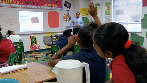 SchoolSmartKC girl raising her hand