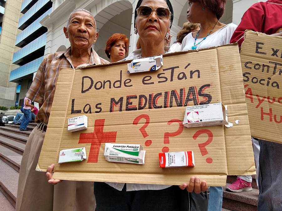 Venezuelan citizens hold signs asking: Donde están las medicinas? (Where are the medicines