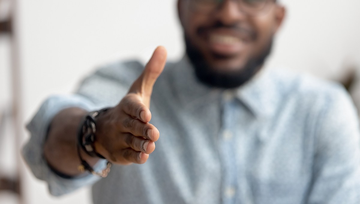 An African-American businessman reaches out for a handshake