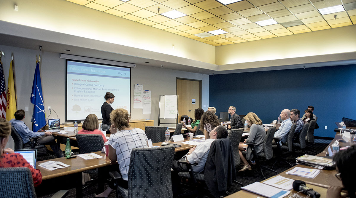 A presentation in a conference room. Photo courtesy of City Alive.