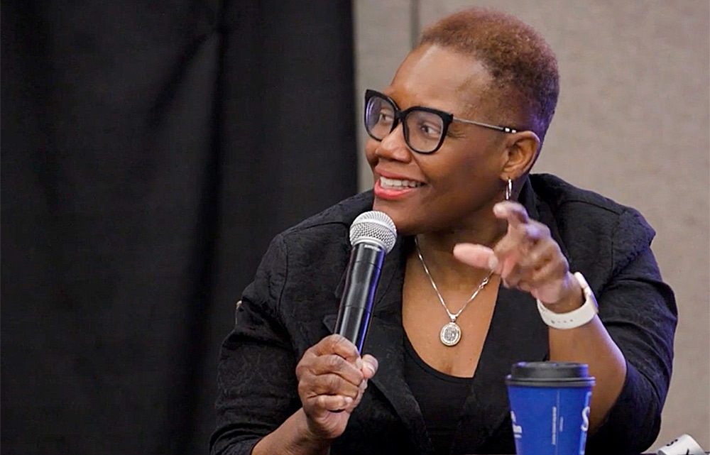 A photo of Karen Freeman-Wilson speaking into a microphone