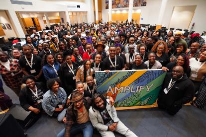 Amplify attendees pose for a group picture.