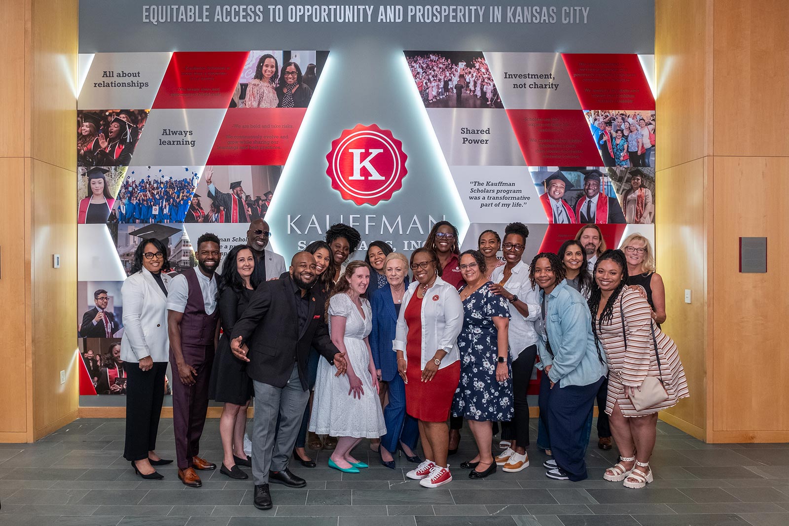 Kauffman Scholars staff poses in front of the KSI Legacy Wall in the Kauffman Foundation Conference Center.