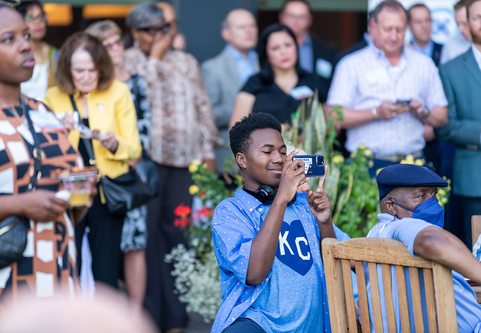 Dr. DeAngela Burns-Wallace's son, Xavier, takes a photo during her opening remarks at the Kauffman Foundation Open House event Sept. 28, 2023.