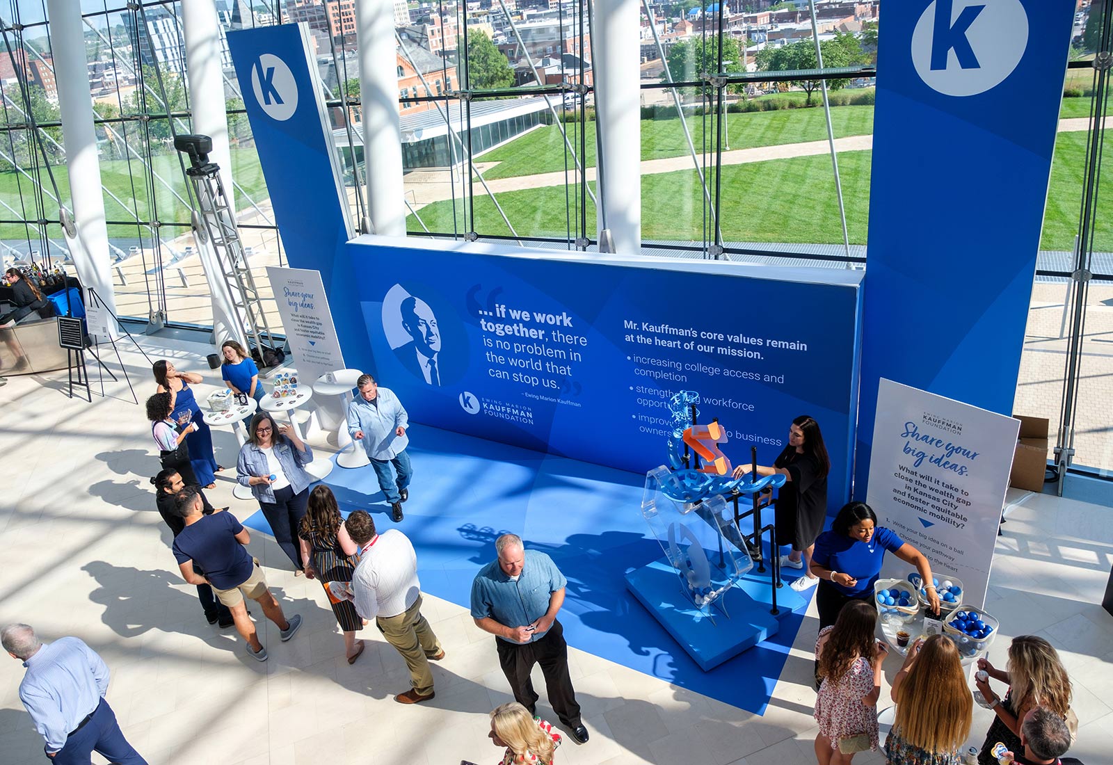 TEDxKC 2024 attendees gather at the Kauffman Foundation's heart installation at the Kauffman Center for Performing Arts