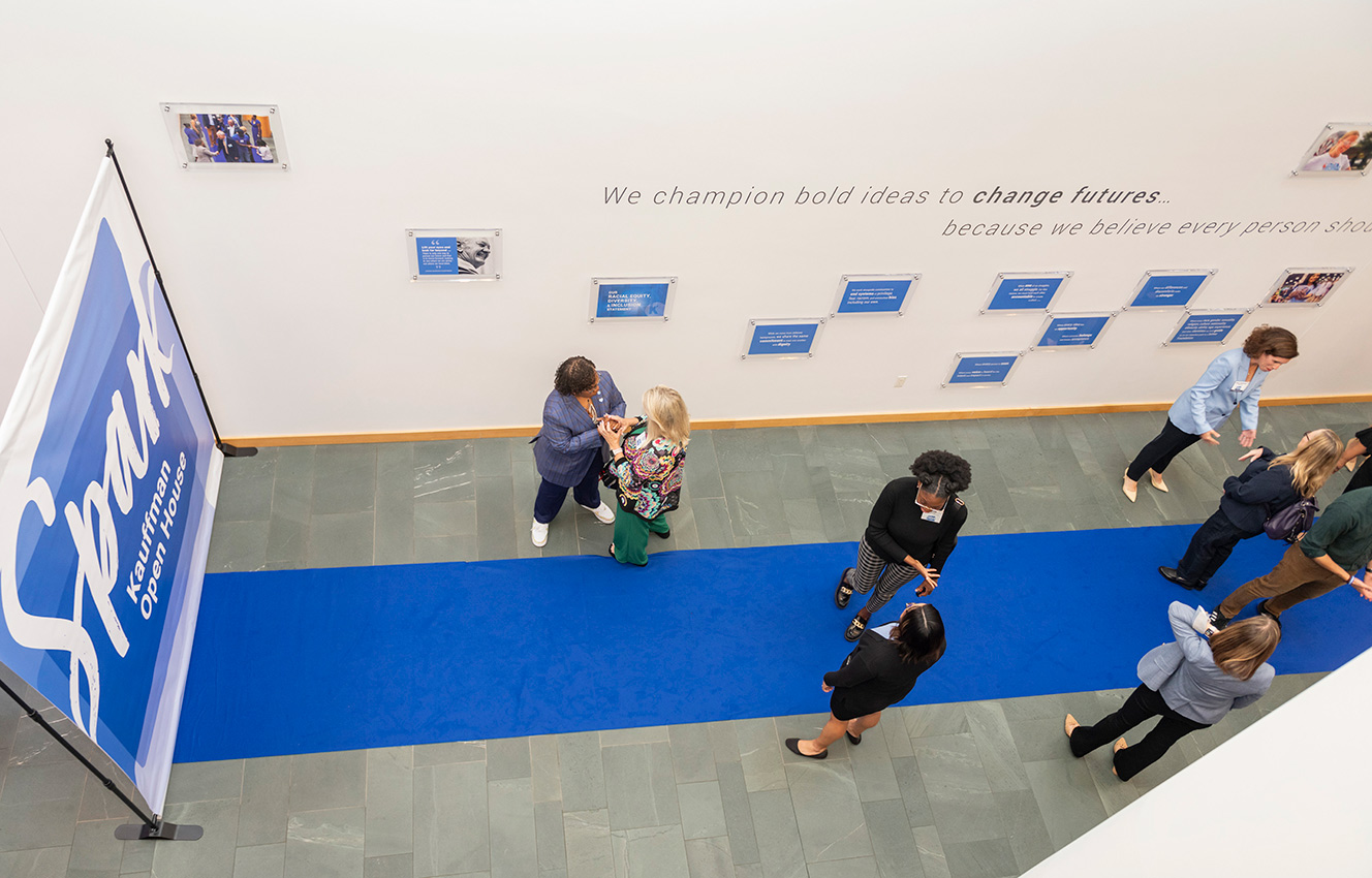 Community members walk the blue carpet at the Ewing Marion Kauffman Foundation Spark Open House event