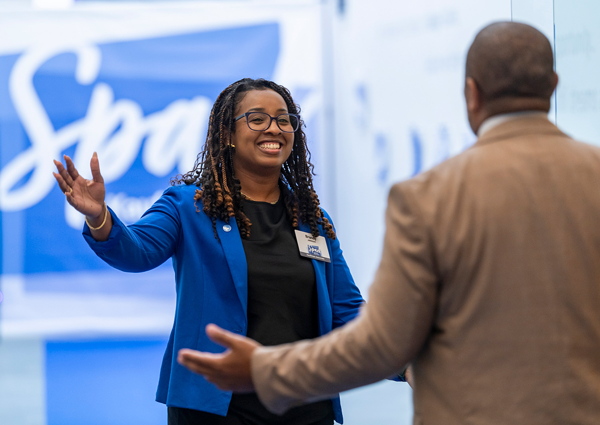 Brandy Johnson, Chief People Officer, greets community member at the Ewing Marion Kauffman Foundation Spark Open House event.