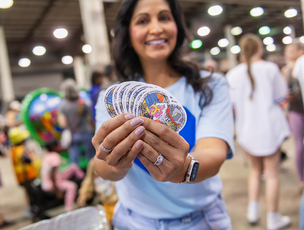 Veronica Solis Galicia holds stickers from the Parade of Hearts event